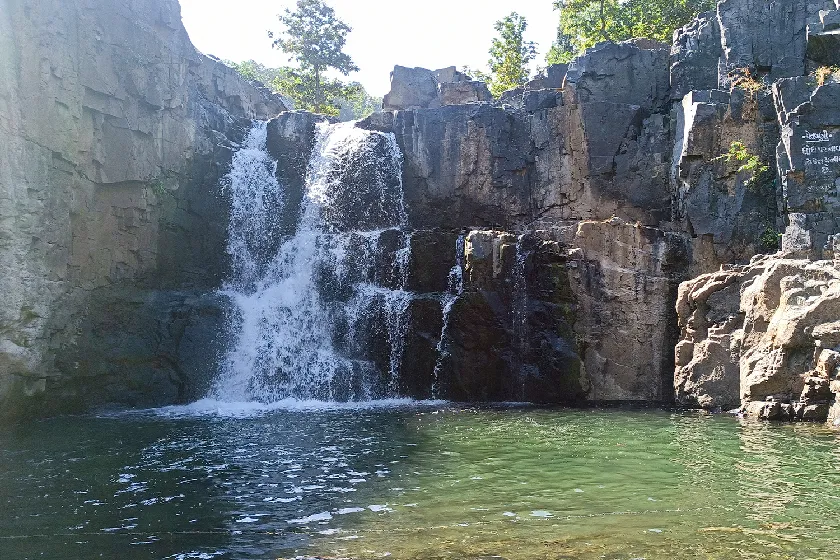 Zarwani Waterfall cascading through rocky cliffs near Statue of Unity, Gujarat